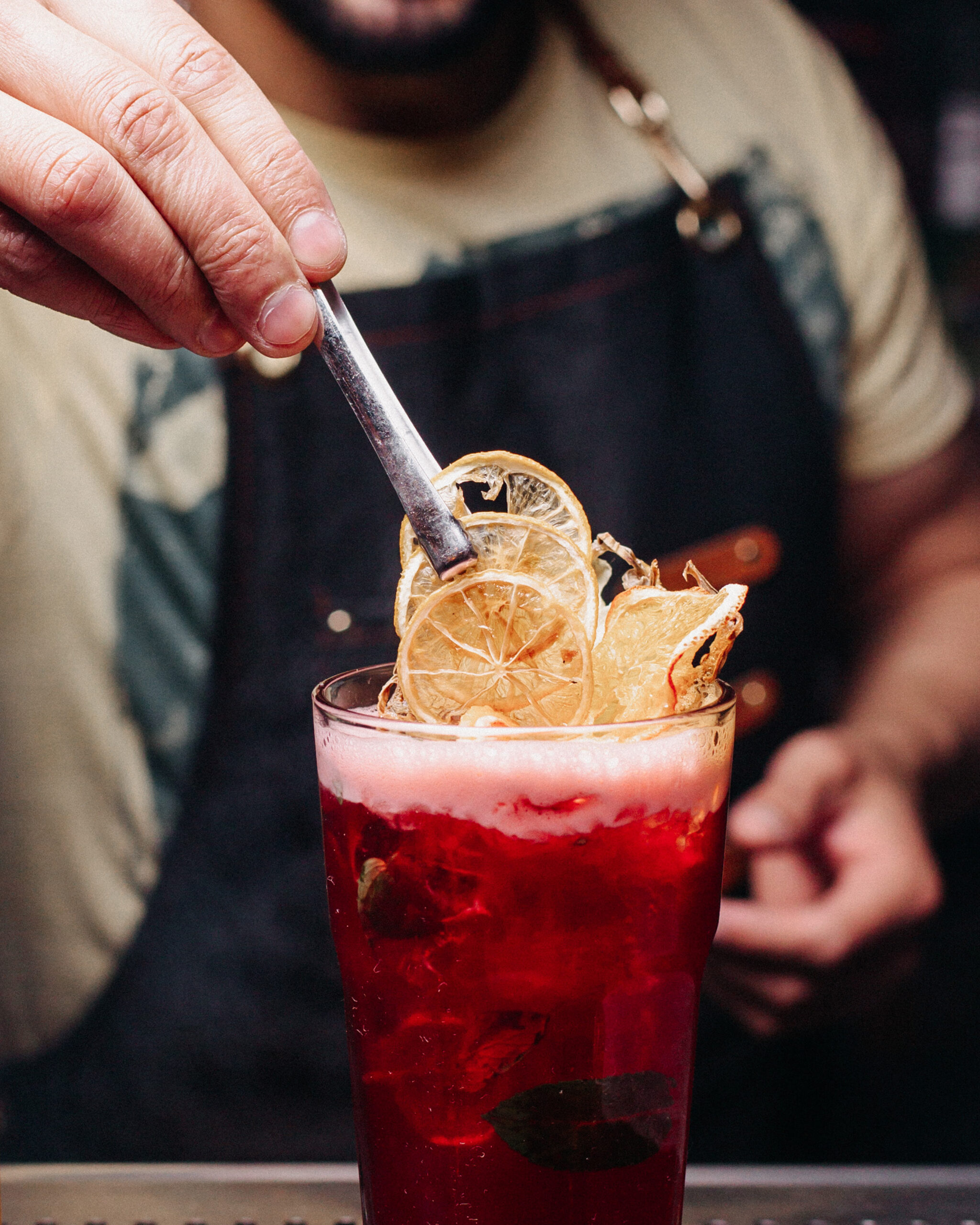 front-view-bartender-preparing-red-drink