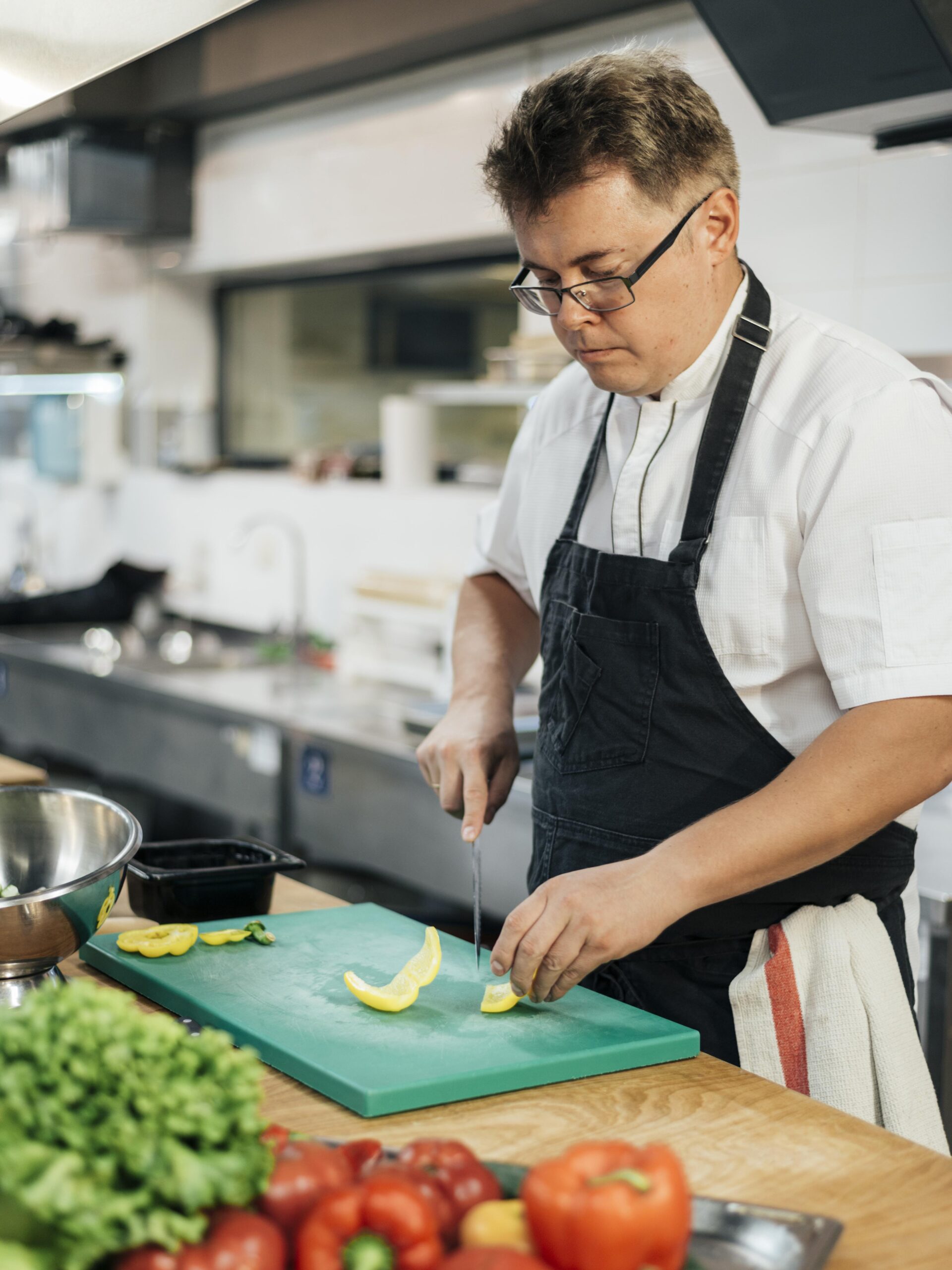 side-view-chef-cutting-vegetables